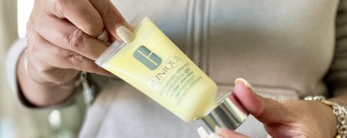 woman holding a yellow bottle of Clinique Dramatically Different Lotion