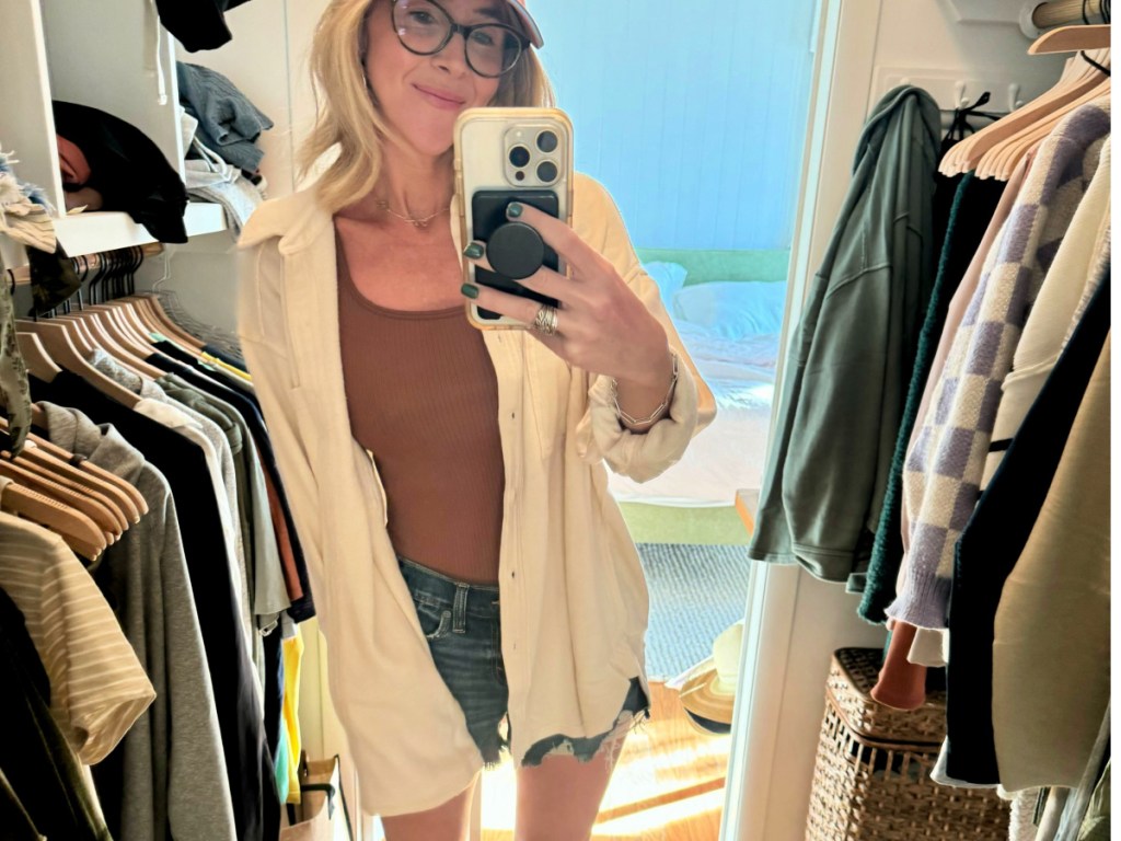 woman wearing cream colored LumberJane Fleece Shirt and taking selfie in closet