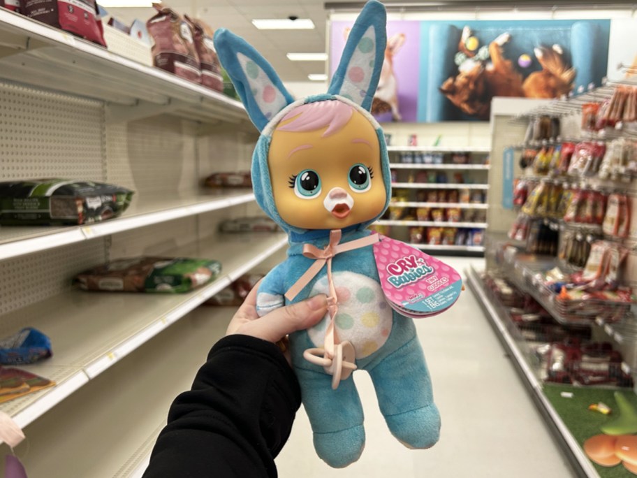 hand holding up a blue Easter Bunny Baby Doll in store