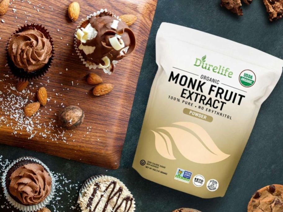A bag of Durelife Monkfruit Extract next to a cutting board with various baked goods on and around it