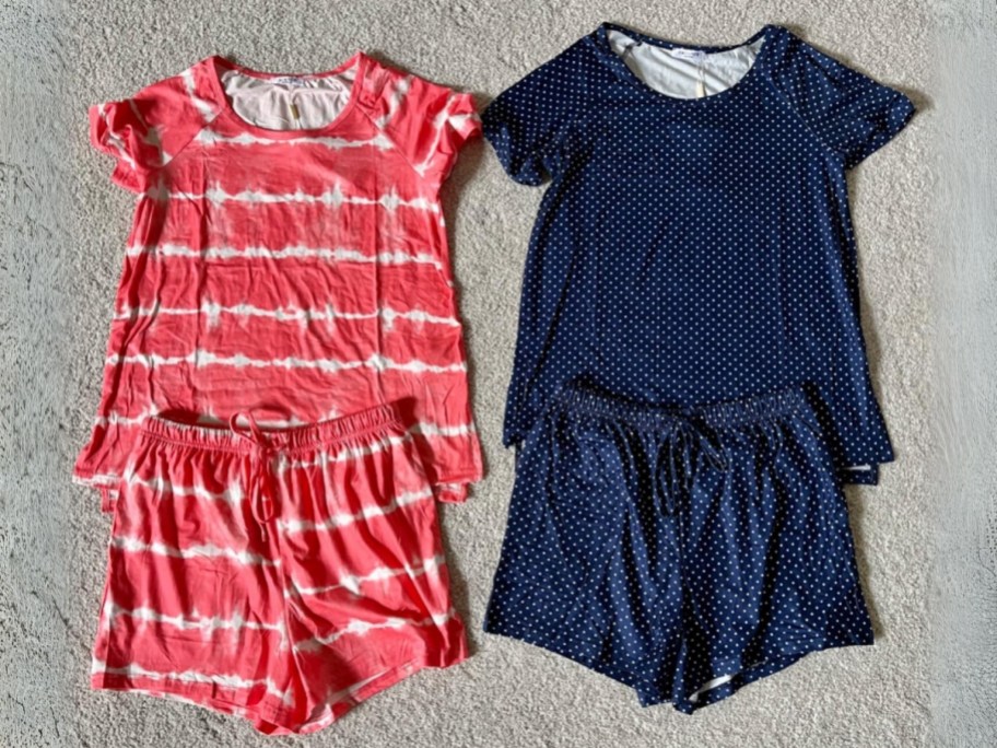 coral and white stripe and navy blue and white dots pajama sets laying in floor