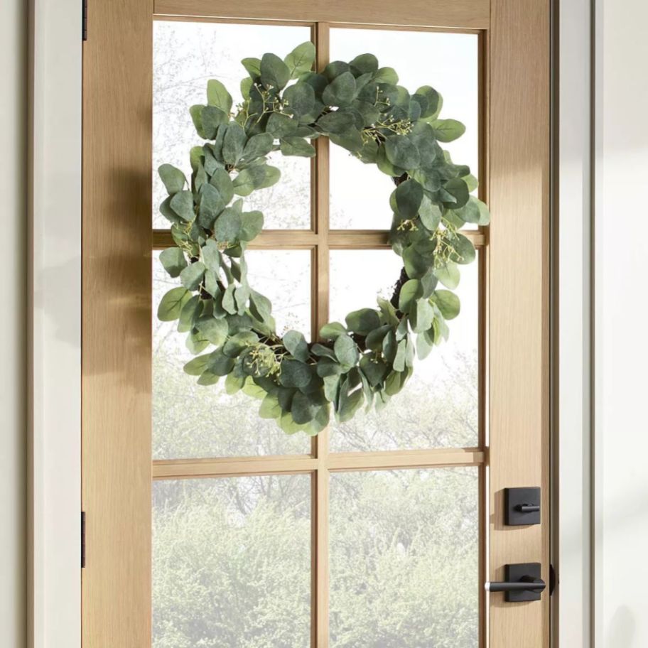 an eucalyptus wreath on a door