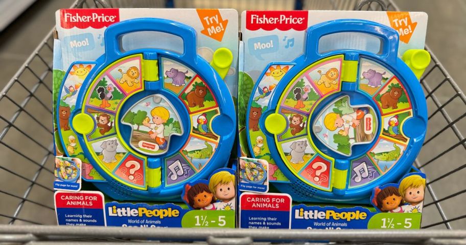 two Fisher Price Little People See N Say toys in a shopping cart