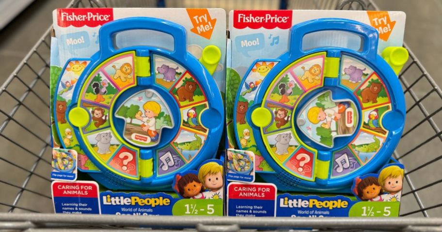 two Fisher Price Little People See N Say toys in a shopping cart