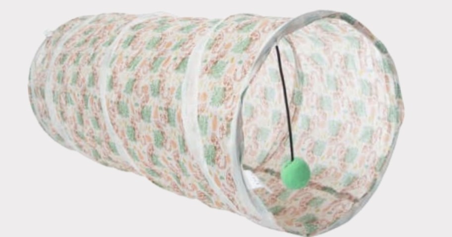 large cat tunnel toy with a jungle print and green ball toy hanging from it