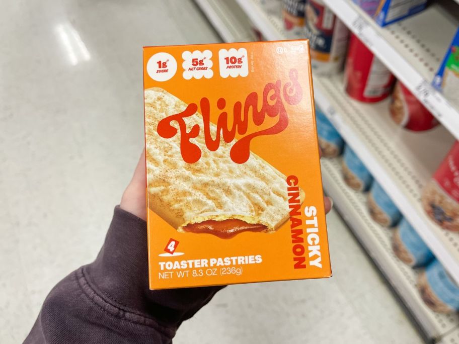 A person holding a box of Flings Toaster Pastries