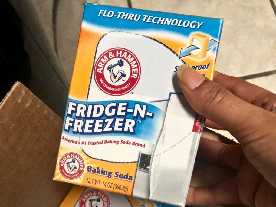 hand holding box of Arm & Hammer Fridge-N-Freezer Odor Absorbing Baking Soda