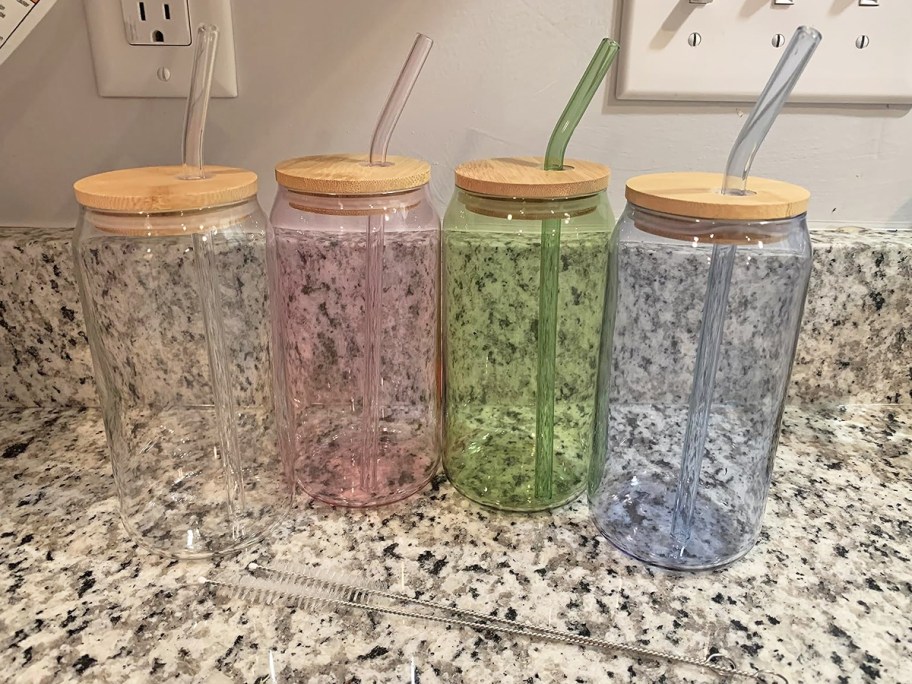 pink, blue, green and clear glass cups with matching straws on counter