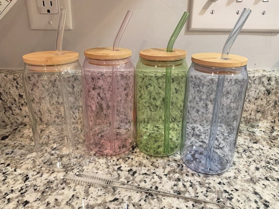 pink, blue, green and clear glass cups with matching straws on counter