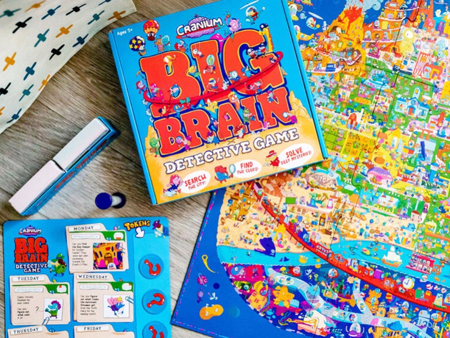 Funko Cranium Big Brain Detective Game laid out on floor with box on top of game pieces