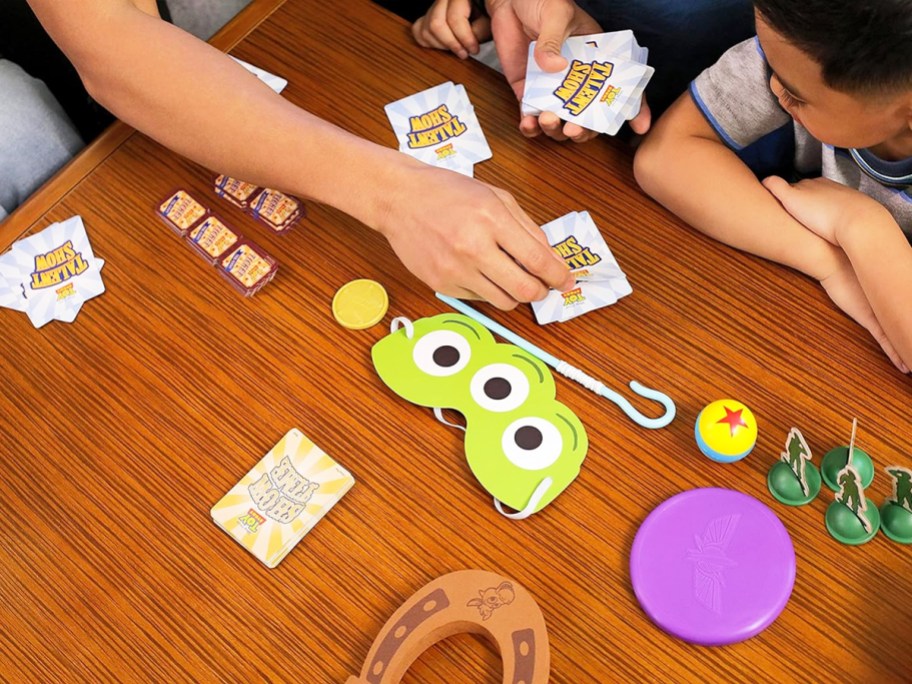 family playing Funko Disney Pixar Toy Story Talent Show Game on table