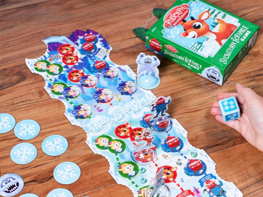 child playing Funko Rudolph The Red-Nosed Reindeer Snowstorm Scramble Game on table
