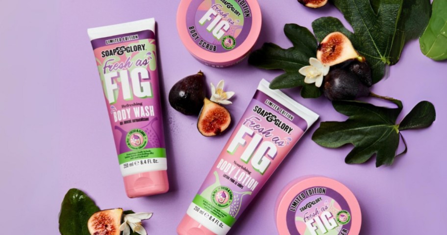 Soap & Glory Fresh as Fig body wash, body lotion and body scrubs laid out with figs and fig leaves