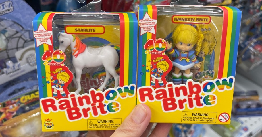 handholding Rainbow Brite and Starlite mini figures in boxes