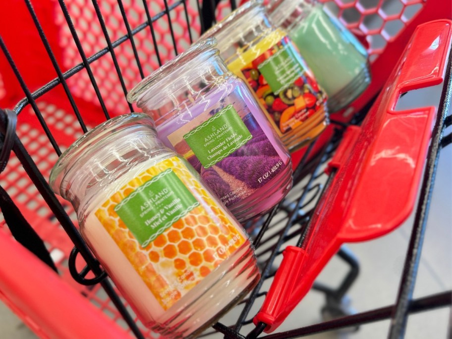 various scents of Ashland Jar Candles in a red Michaels shopping cart