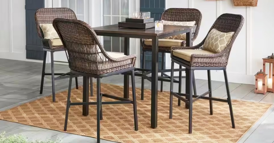 tall brown wicker patio dining set on outdoor area rug