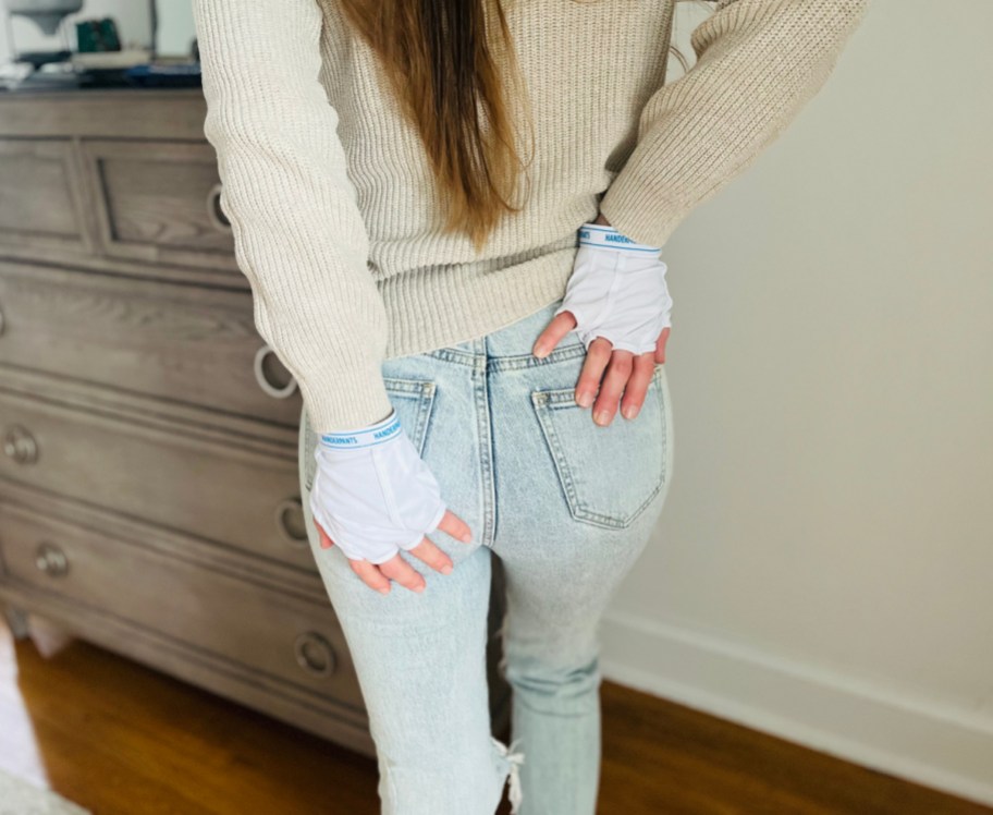 Woman wearing a pair of Handerpants gloves, underpants for your hands by Accoutrements LLC on Amazon, and one of our favorite white elephant gifts