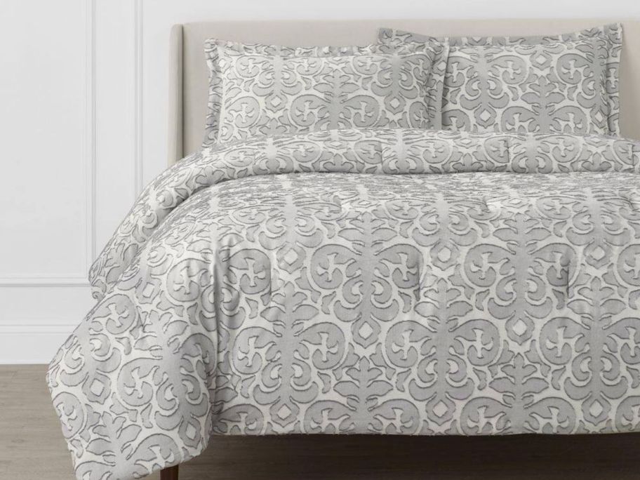 A gray Jacquard Full/Queen Comforter Set on a bed