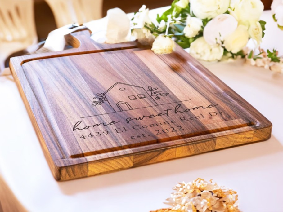 engraved cutting board that says home sweet home with home address on it