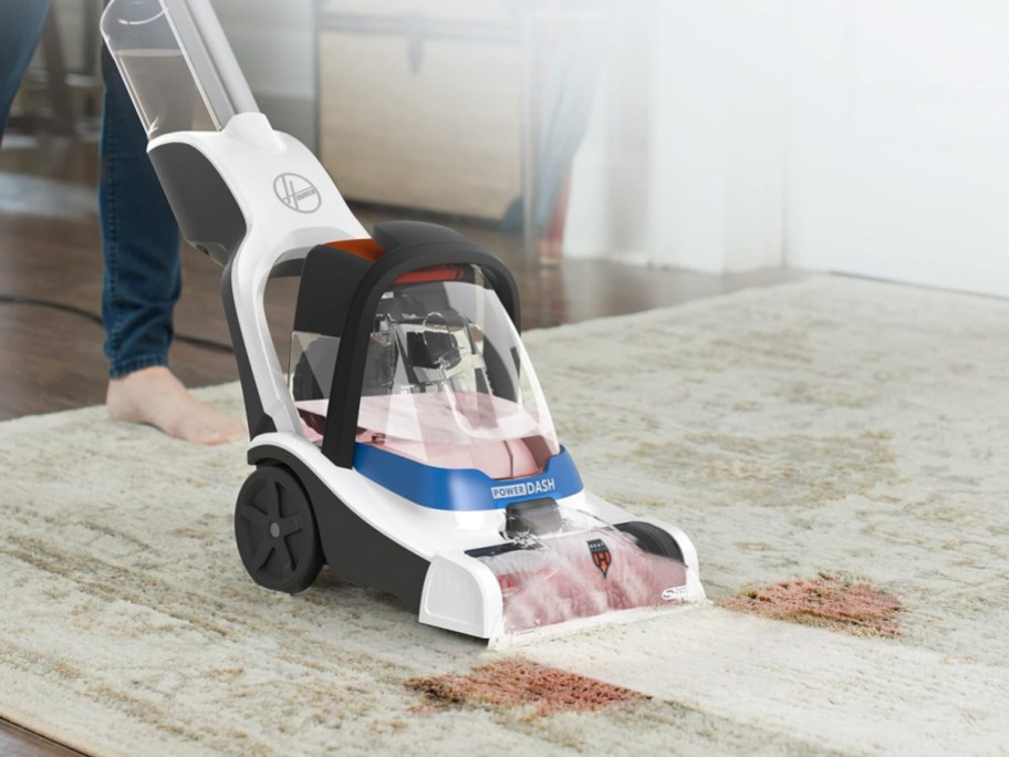 Hoover PowerDash Pet Compact Carpet Cleaner being used to clean a carpet stain
