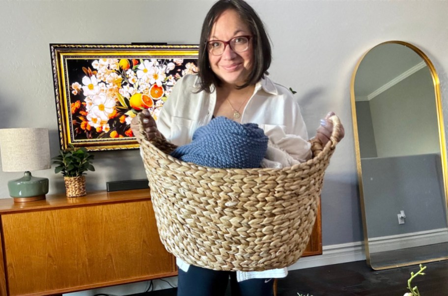 Woman holding a hyacinth basket from Walmart's spring decor 2024 collection