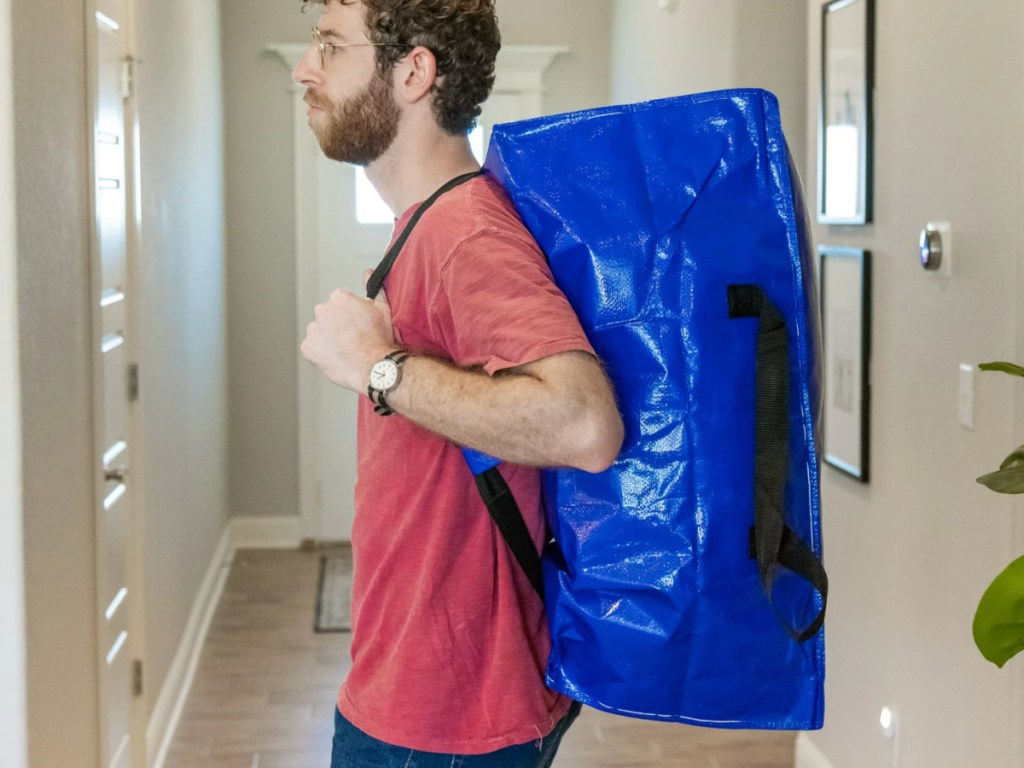 man wearing hyper tough blue moving bag as backpack