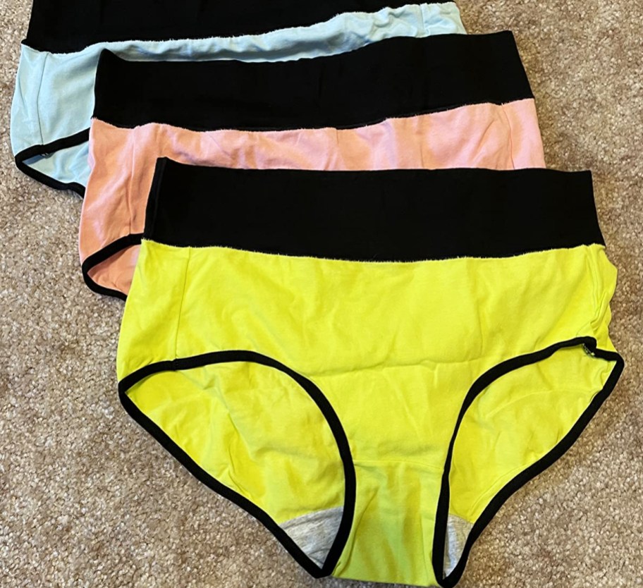 pair of yellow, pink, and blue underwear with black waistbands