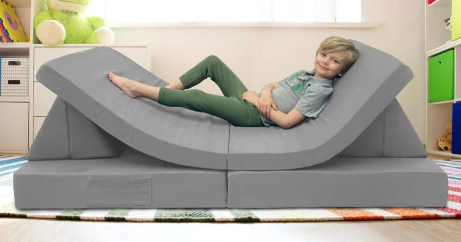 A child laying on an Imaginarium Kids and Toddler Play Couch, Gray