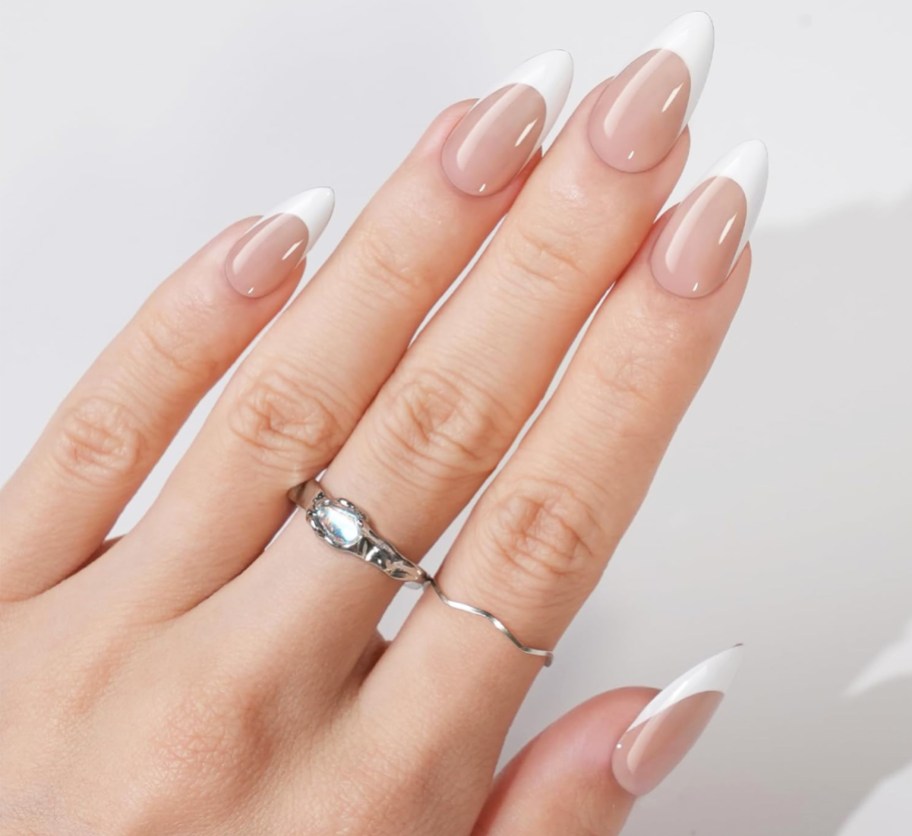 hand showing almond shaped french-tip press-on nails
