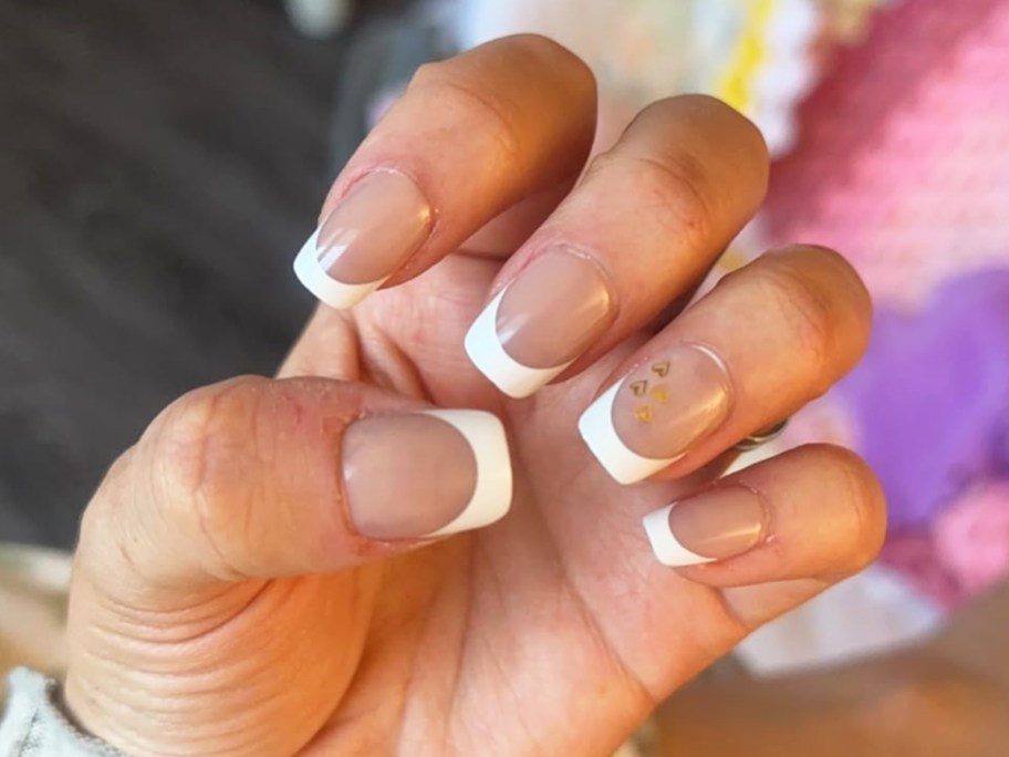 hand showing french-tip press-on nails