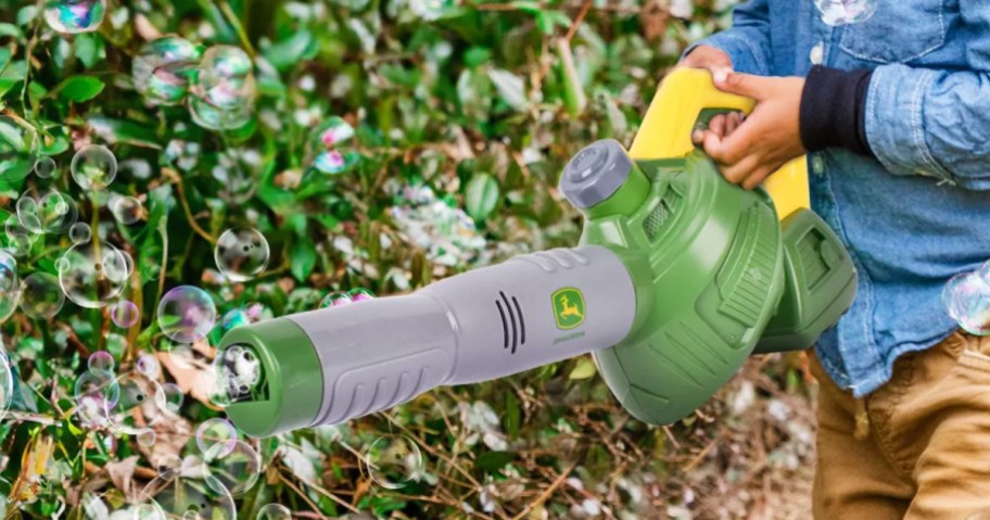 boy playing with John Deere Bubble Leaf Blower