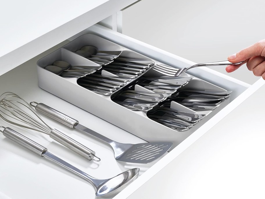 hand grabbing fork from utensil organizer inside drawer