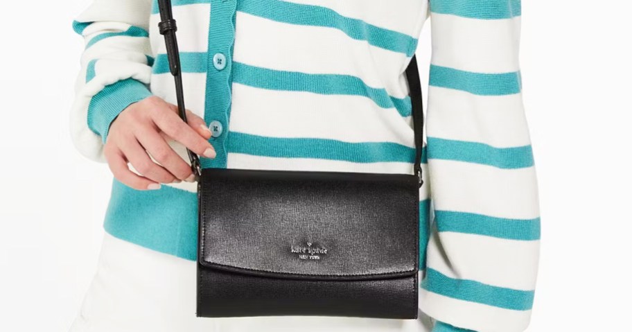 woman in white and blue striped sweater with black crossbody bag