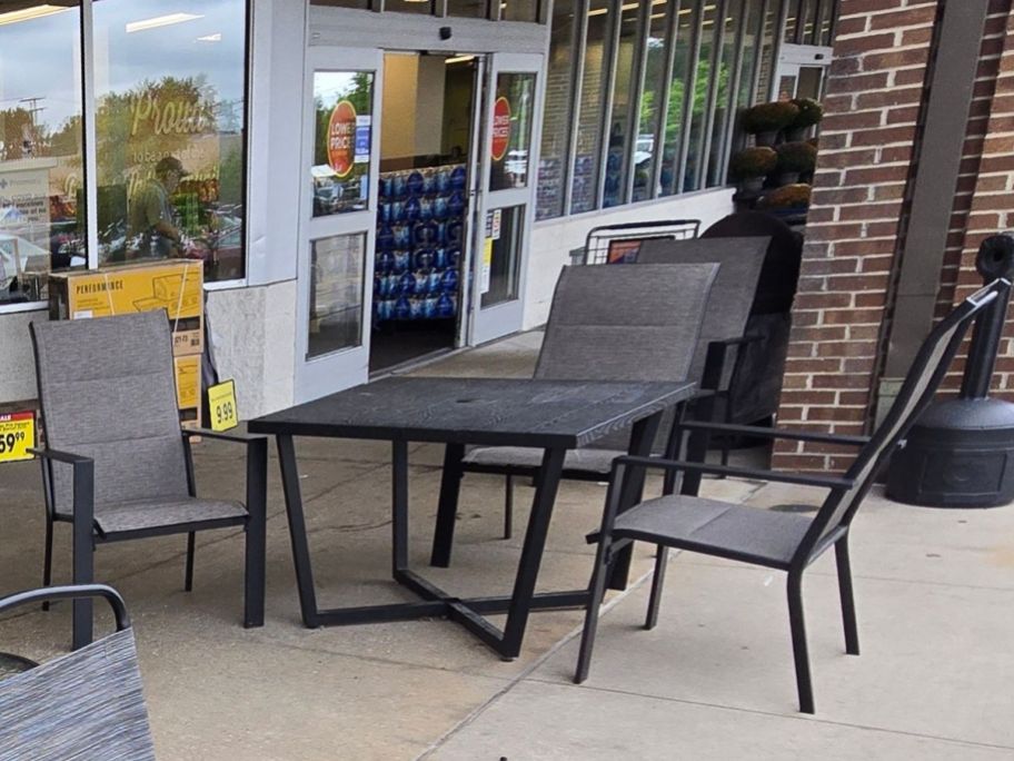 A patio set outside a grocery store