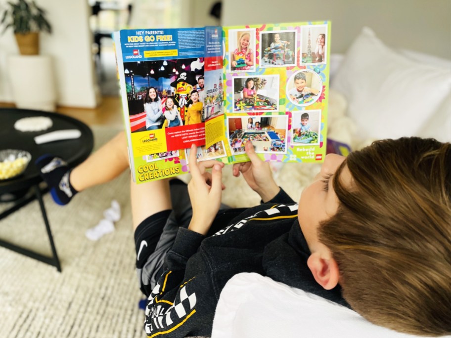 boy on couch reading lego magazine