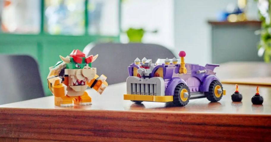 a lego Bowser figure with a purple lego cars
