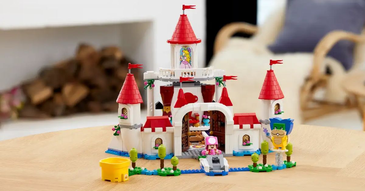 an assembled lego peaches castle expansion set featuring a white castle with a red roof