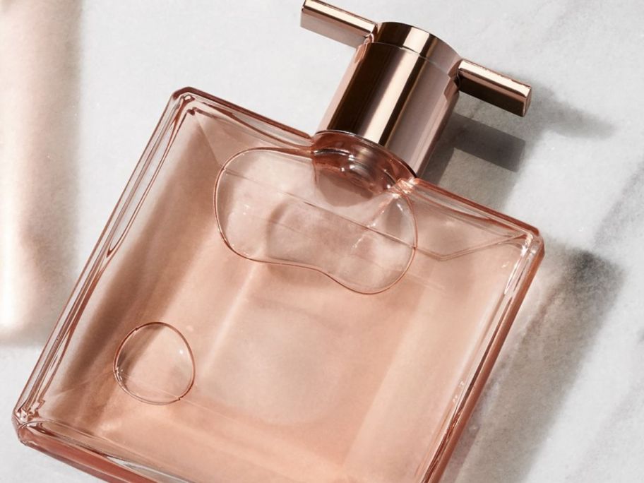 A bottle of Lancome Idole Perfume