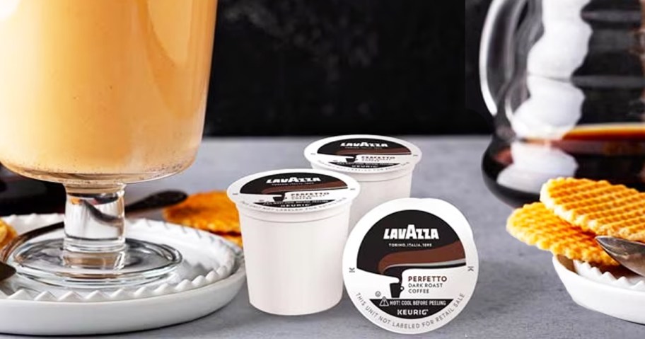 Lavazza k-cups near coffee drink and plate of cookies