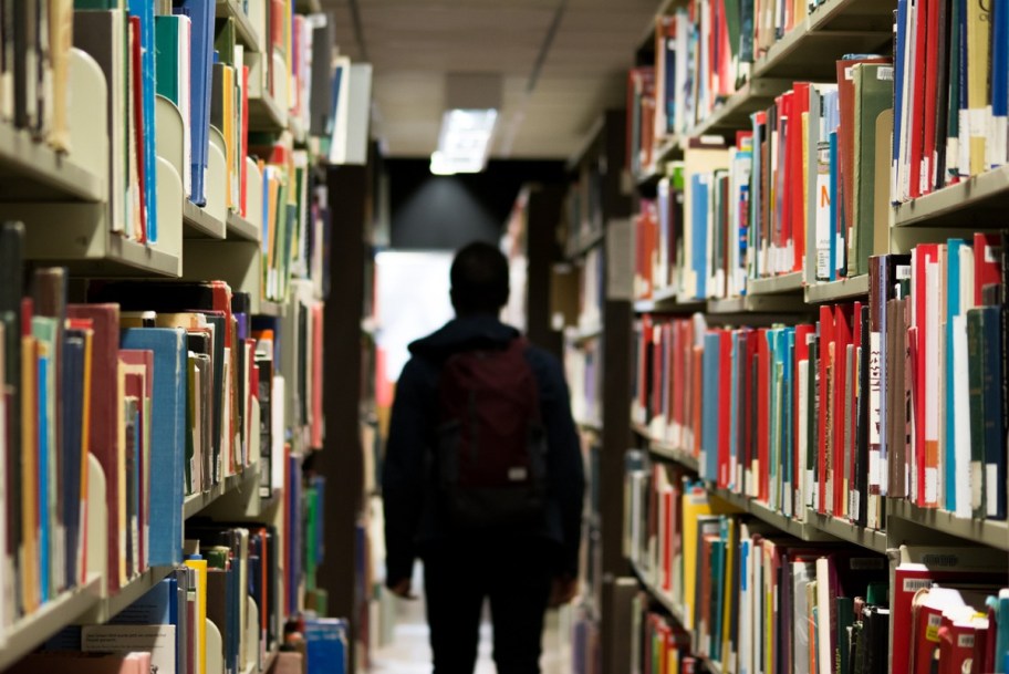 A student walking through a school library
