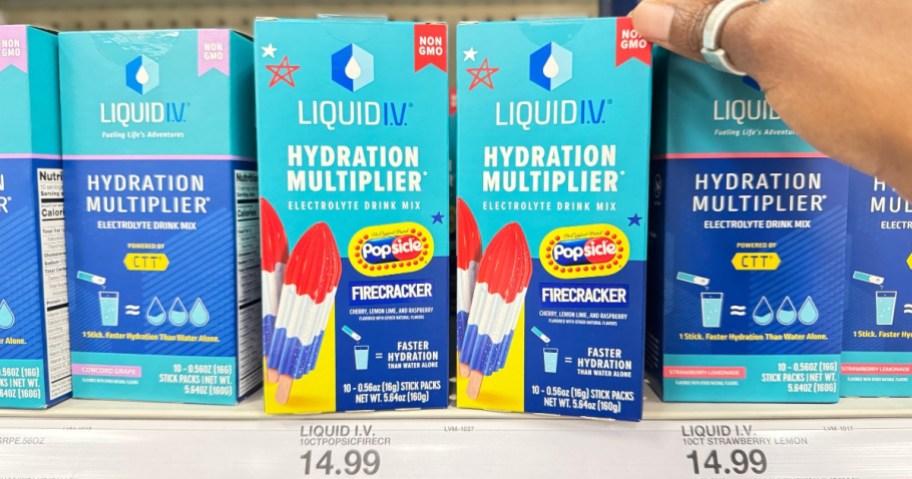 hand reaching for a box of Liquid I.V. packets in Popsicle Firecracker flavor on a store shelf