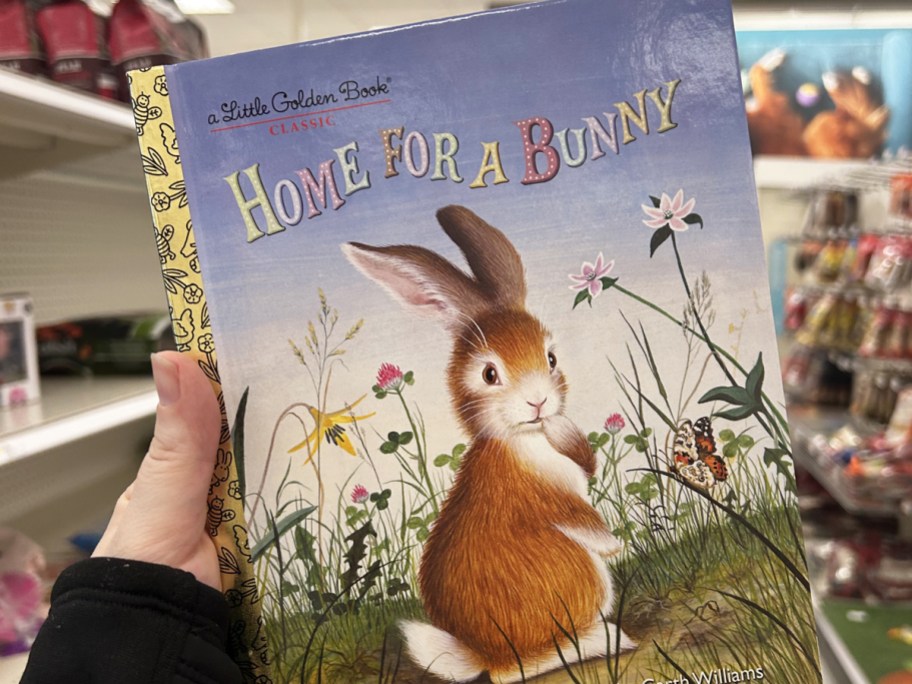 hand holding up Little Golden Books Home for a Bunny book in store