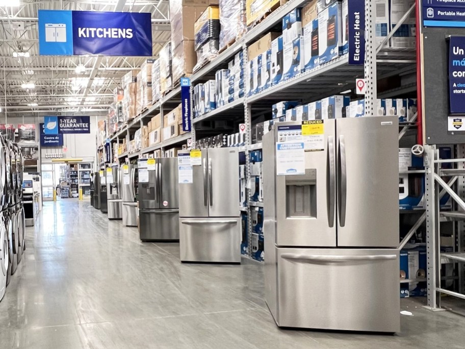refrigerators lining aisle in lowe's store