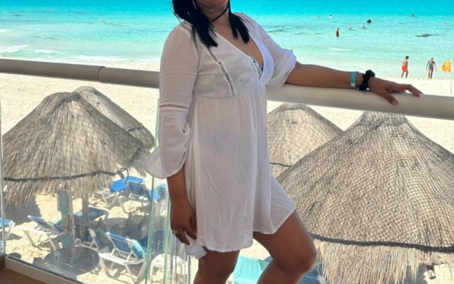 a woman in a white swimsuit coverup