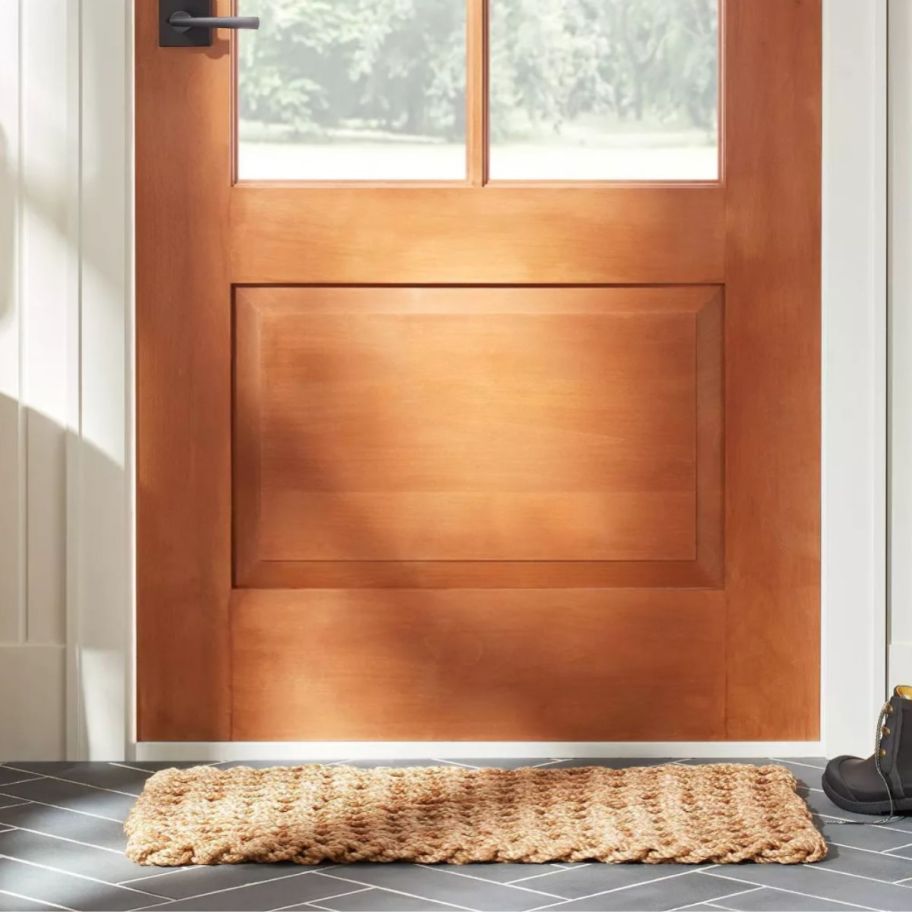 a juste doormat in front of a door