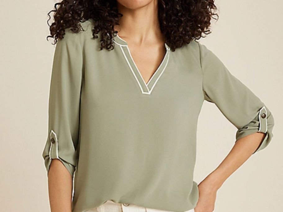 Woman wearing a blouse from maurices