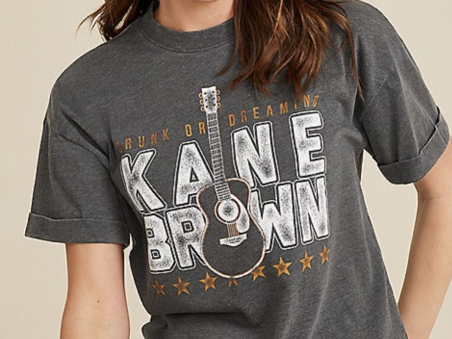 Woman wearing a Kane Brown Graphic Tee from Maurices