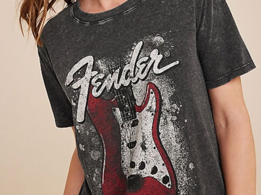 Woman wearing A graphic tee with a Fender Guitar on it from Maurices