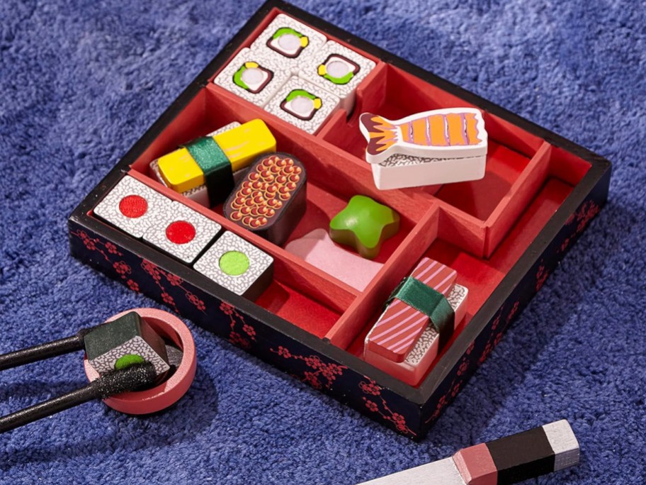 wood bento box filled with wooden sushi pieces