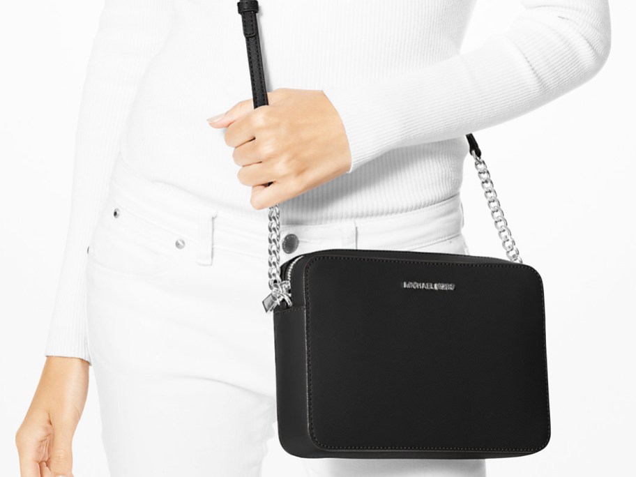 woman in white outfit with black crossbody bag